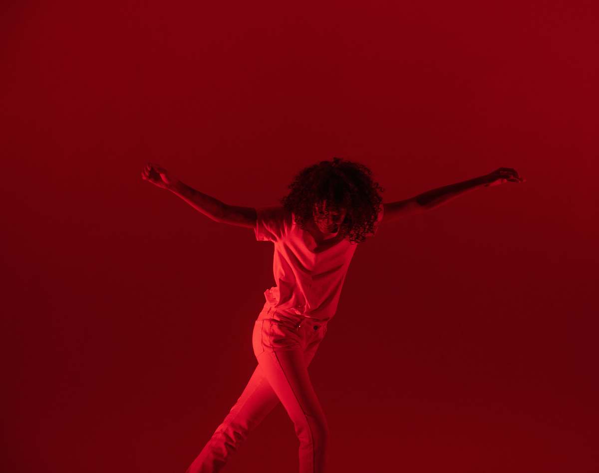 dance pose photography of woman dancing near red background human